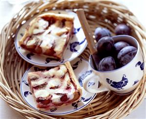 Plum cake with quark and fresh plums on tray