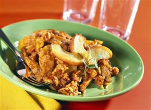 Rice with meat and apples on green plate