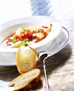 Tomato soup with fish, shrimps and mangetouts