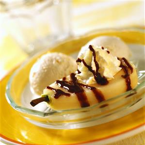 Poached pear with chocolate sauce, cream & vanilla ice cream