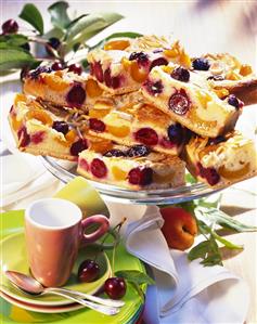 Apricot & cherry cake with slivered almonds on cake plate