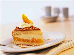 Piece of apricot and hazelnut gateau with cream