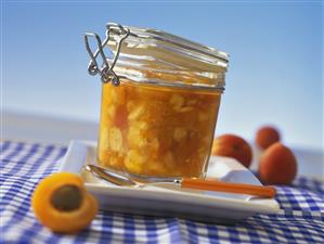 Apricot preserve with banana slices in jar