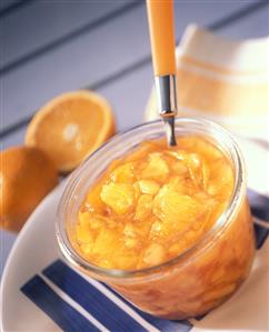 Peach and orange preserve in preserving jar