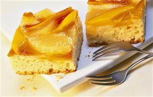 Pieces of cake with exotic fruits on white platter