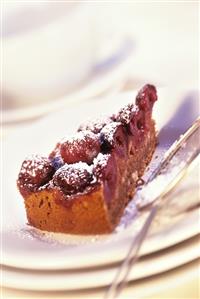 Piece of bread cake with cherries and icing sugar