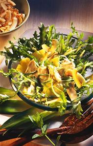 Exotic poultry salad with pineapple on curly endive