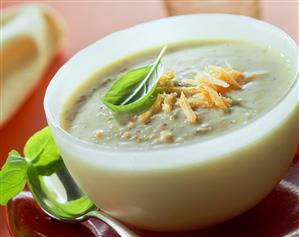 Green rye soup with grated carrots and basil