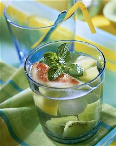 Punch with exotic fruits in glass