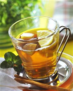 Apple and herb tea punch in glass cup