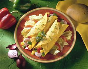 Shrimp and mango wraps with peppers on red plate