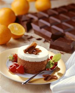 White & brown chocolate cakes with chocolate curls & berries