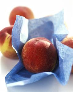 Peaches, one on blue paper