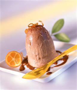 Iced chocolate pudding garnished with kumquat