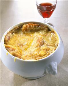 Onion soup in soup tureen; red wine glass (1)