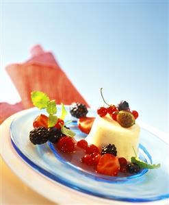 Turned-out vanilla blancmange with berry sauce