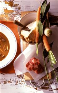 Goulash soup with ingredients (vegetables, meat, bay leaf)