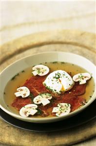 Carpaccio soup with poached egg and mushrooms