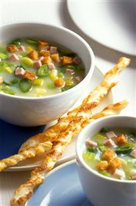 Leek soup with ham, cheese sticks and croutons