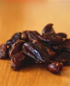 Dried dates on wooden background