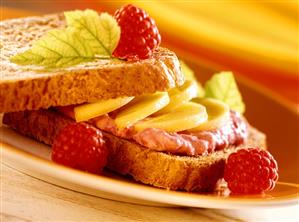 Sweet fruit and soft cheese sandwich on plate