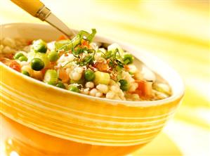 Pearl barley soup with vegetables and cheese