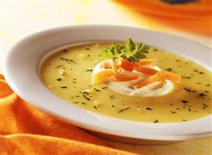 Potato soup with salmon and sour cream on plate