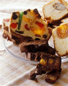 Slices of different fruit cakes on glass plate