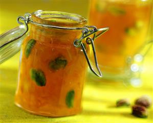 Orange marmalade with pistachios in jar