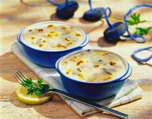 Fish soup with mushrooms and toasted cheese topping