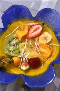 Exotic fruit salad in flower-shaped bowl