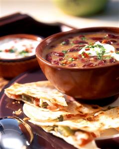 Mexican bean soup with sour cream and quesadillas