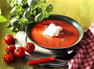 Tomato soup with cheese cream and fresh basil