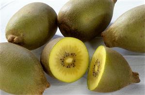 Yellow kiwi fruits, one halved