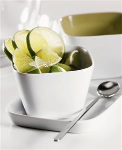 Lime slices and wedges in white bowl