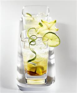 Caipirinha with ice cubes, carambola and limes