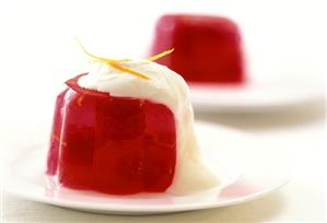 Red jelly with raspberries and whipped cream