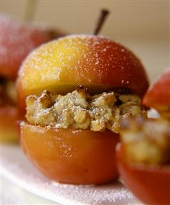 Baked apple with nut filling and icing sugar