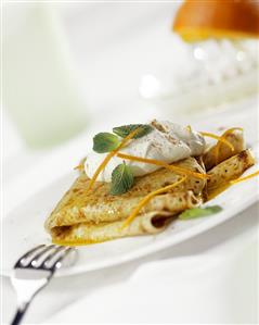 Crepes suzettes with cream and mint