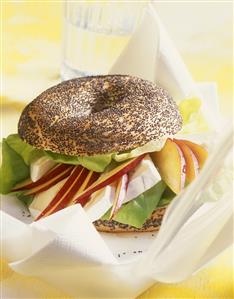 Poppy seed bagel with lettuce, Camembert and peach