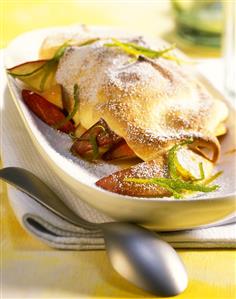 Baked peaches with icing sugar and lime zest