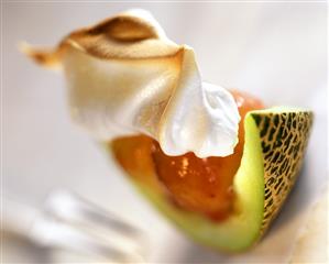 Melon wedge with strawberry puree and meringue