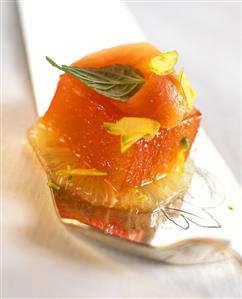 Blood orange jelly on grapefruit slice, decorated with papaya