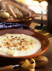 Potato soup with croutons and herbs; meat platter
