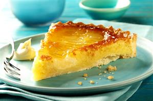 Piece of pear tart on blue plate