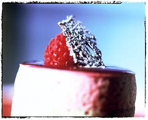 Raspberry tartlet with chocolate leaf and icing sugar