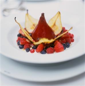 Poached red wine pear with pear crisps and berries