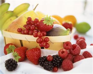 Still life with fresh berries, pear, fig etc.