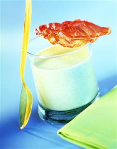 Pea soup in glass with fried rasher of bacon