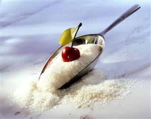 Preserving sugar with scoop and fresh cherry